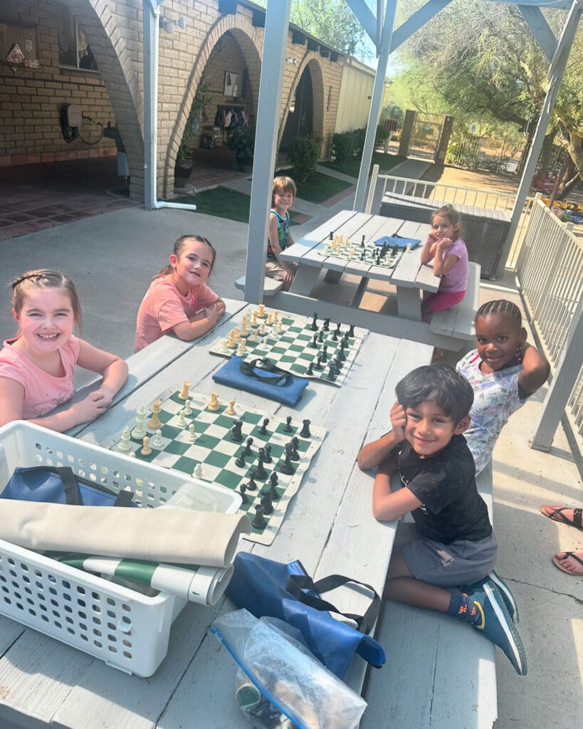 Cave Creek Montessori | Kindergarten children at cave creek playing chess